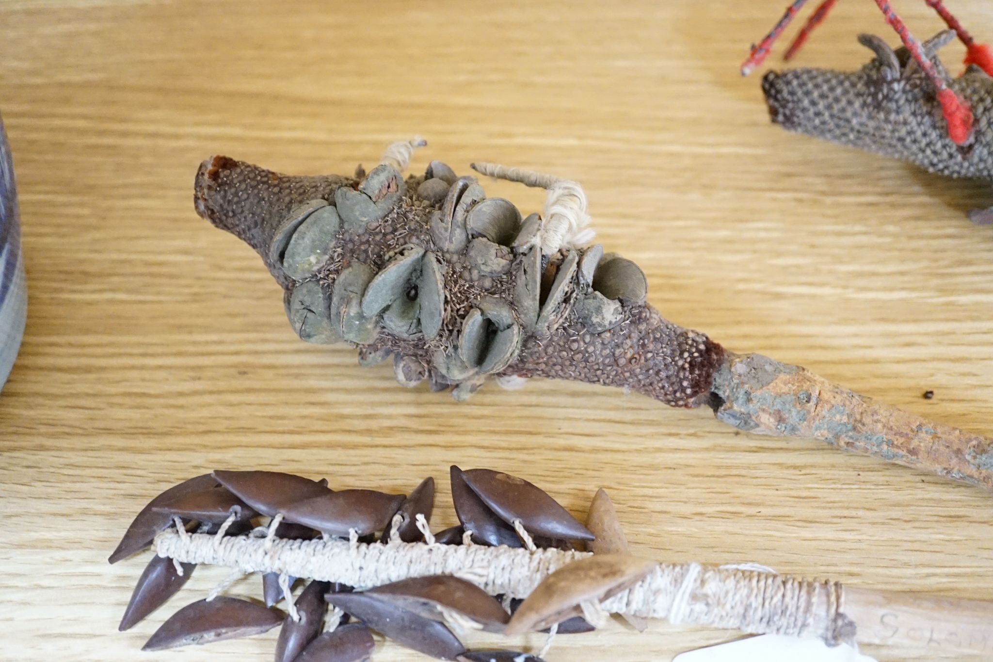 Two Japanese carved wood masks, an African beaded mask and three similar rattles